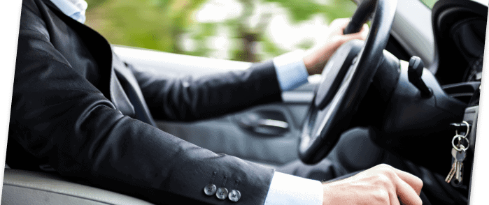 Man Wearing Black Suite Driving a Car 